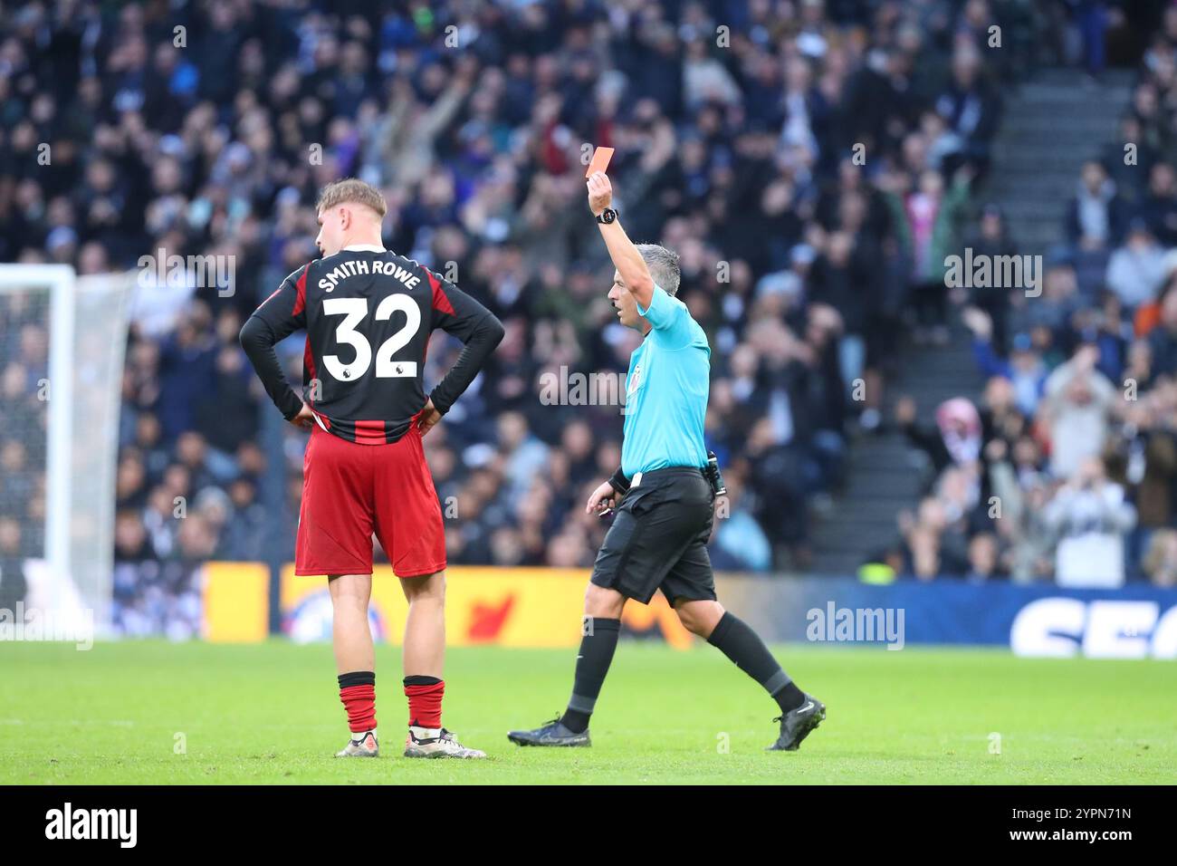 Tottenham Hotspur Stadium, London, UK. 1st Dec, 2024. Premier League Football, Tottenham Hotspur versus Fulham; referee Darren Bond waves away the yellow card he initially awarded Tom Cairney of Fulham after his challenge on Dejan Kulusevski of Tottenham Hotspur for a red card for serious foul play after VAR review. Credit: Action Plus Sports/Alamy Live News Stock Photo