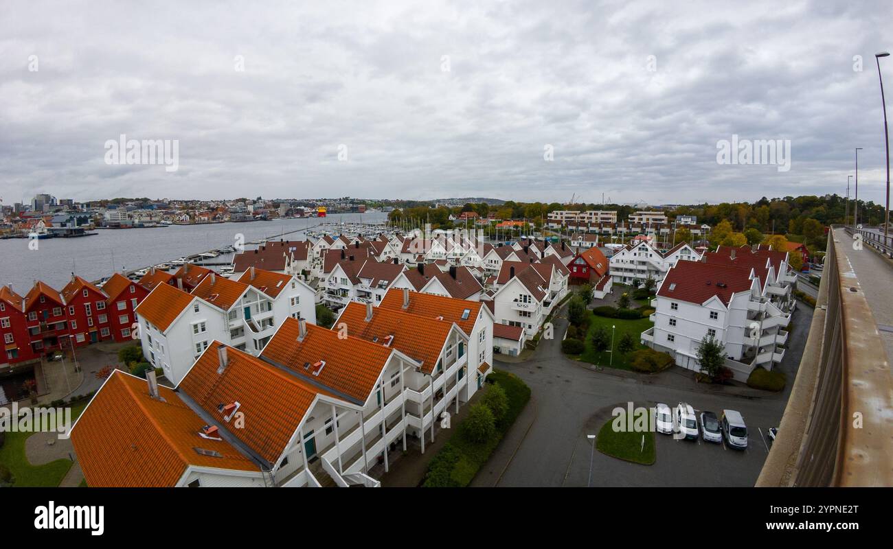 Aerial view of a coastal town with red-roofed houses and a river, under ...