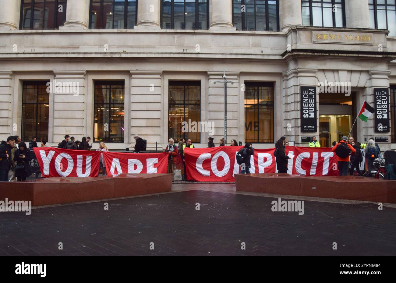 London, UK. 1st December 2024. Activists stage a protest outside the Science Museum against Adani sponsorship. The company, whose founder and chairman Gautam Adani faces fraud charges in USA, is the world's largest producer of coal and, the activists say, has ties to weapons manufacturers supplying Israel. Credit: Vuk Valcic/Alamy Live News Stock Photo