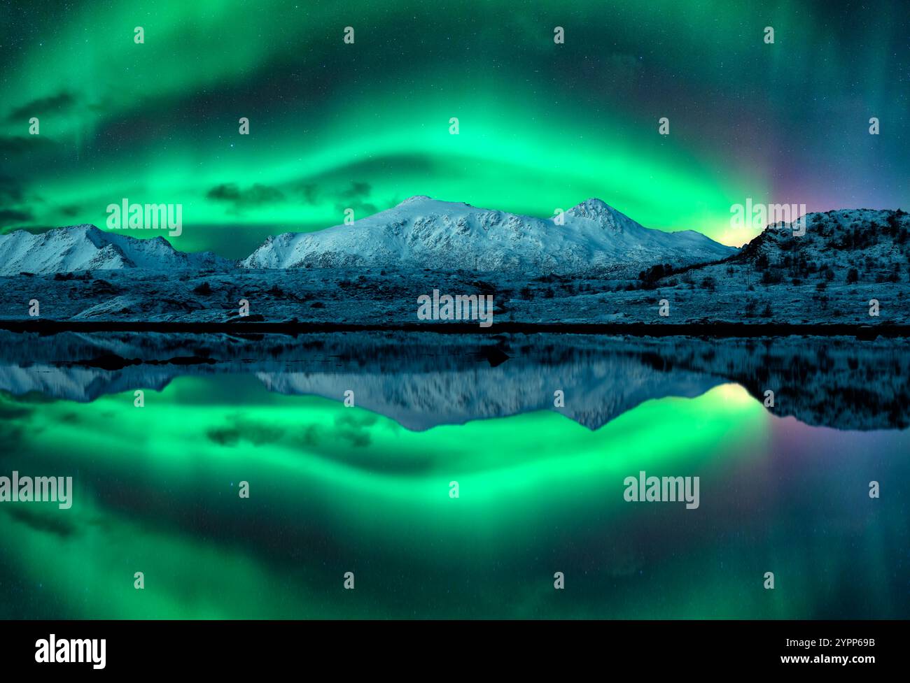Northern lights over the snowy mountains, reflection in water Stock ...