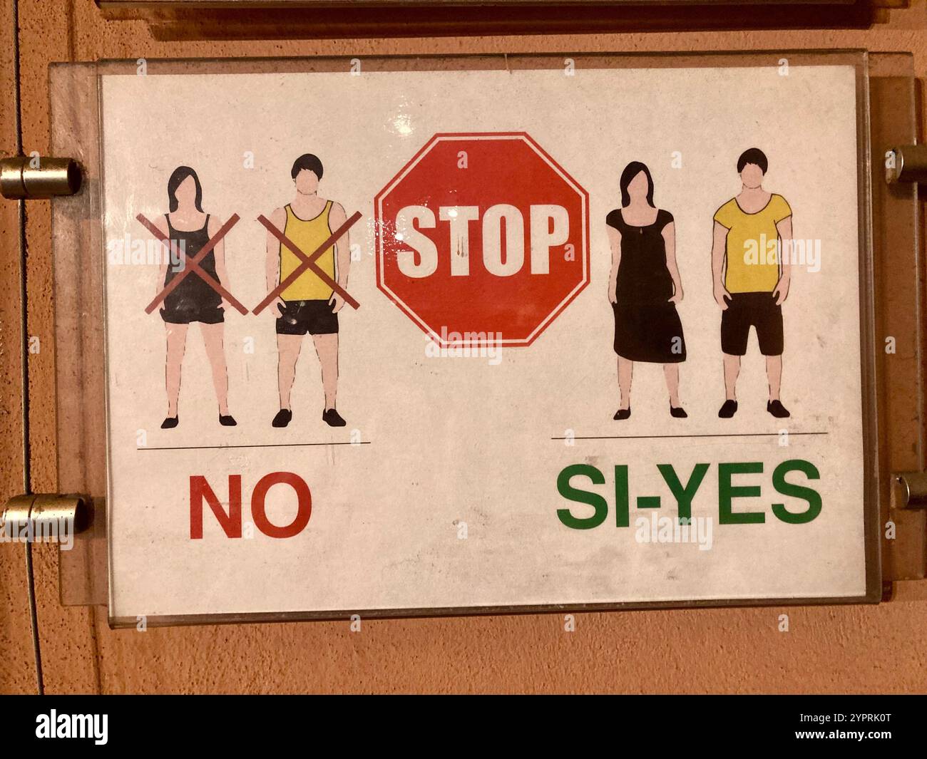 A sign in an Italian church pointing out the proper dress regulation for entering the building: No short sleeves and short pants or dresses - Smartphone Captured Stock Image A sign in an Italian church pointing out the proper dress regulation for entering the building: No short sleeves and short pants or dresses - Smartphone Captured Stock Image