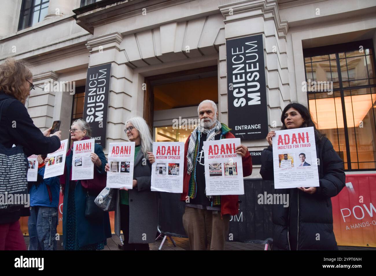 London, UK. 1st December 2024. Activists stage a protest outside the Science Museum against Adani sponsorship. The company, whose founder and chairman Gautam Adani faces fraud charges in USA, is the world's largest producer of coal and, the activists say, has ties to weapons manufacturers supplying Israel. Credit: Vuk Valcic/Alamy Live News Stock Photo