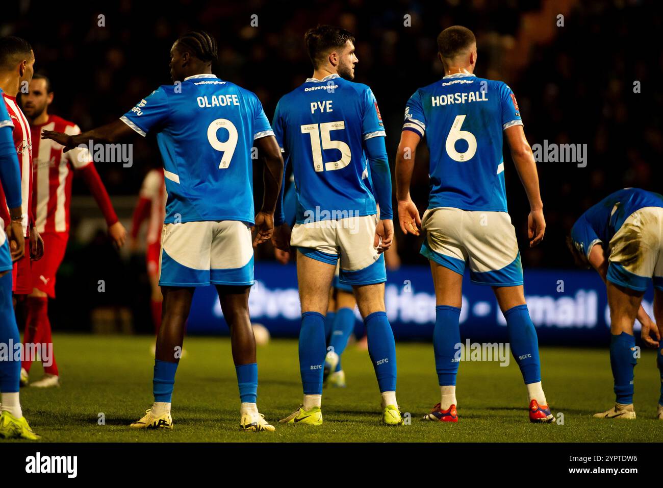 Isaac Olaofe, Ethan Pye and Fraser Horsfall of Stockport County Prepare to defend a Brackley Town Free-Kick in their FA Cup 2nd Round Match. Stock Photo