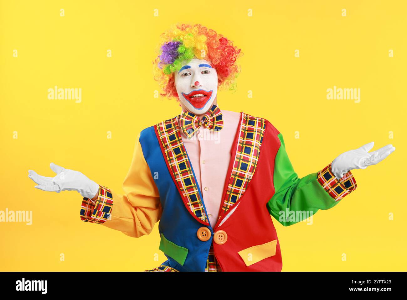Portrait of emotional clown on yellow background Stock Photo - Alamy