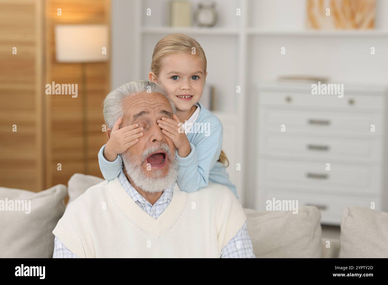 Grandpa and his granddaughter having fun at home Stock Photo