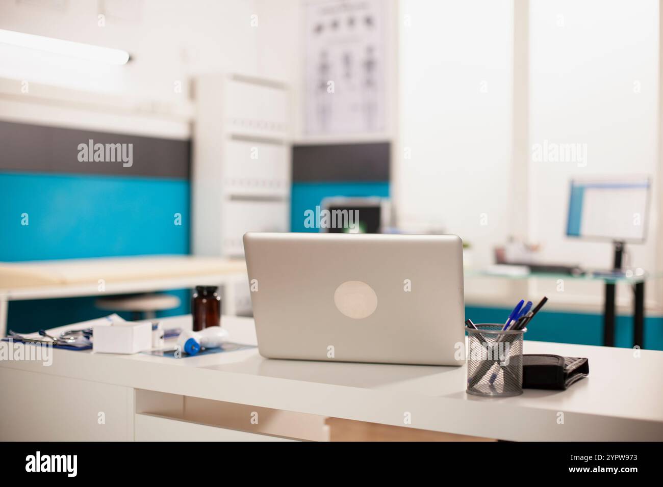 Digital laptop positioned on table in doctors office. Empty organized ...