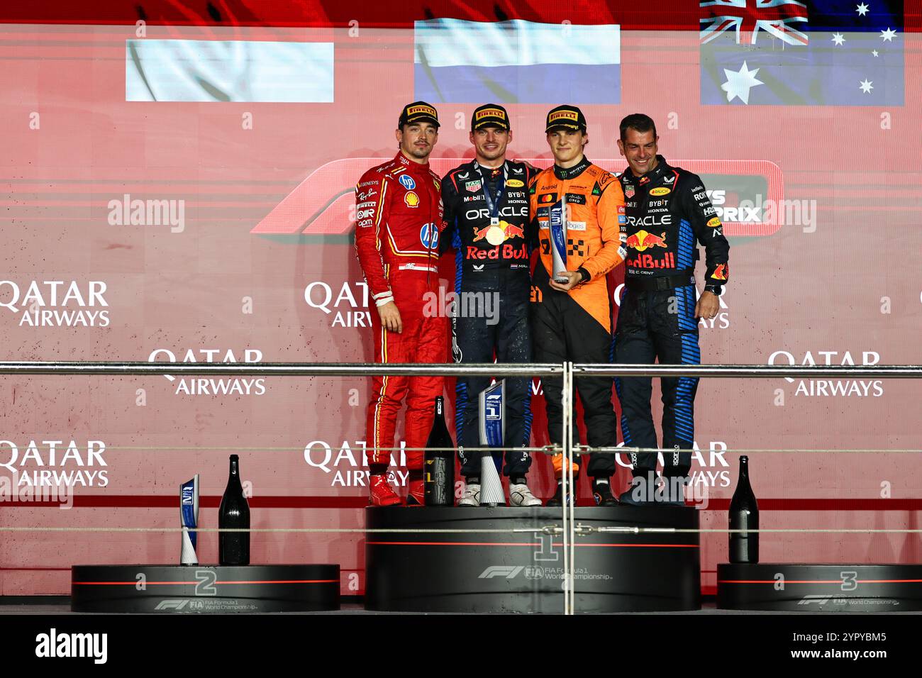 Lusail, Qatar. 1st Dec, 2024. First placed Red Bull Racing's Dutch Driver Max Verstappen (2nd L), second-placed Ferrari's Monaco driver Charles Leclerc (1st L) and third placed McLaren' Australian driver Oscar Piastri(2nd R) pose on the podium after the race of the Qatar F1 Grand Prix at Lusail International Circuit in Lusail, Qatar, Dec. 1, 2024. Credit: Qian Jun/Xinhua/Alamy Live News Stock Photo