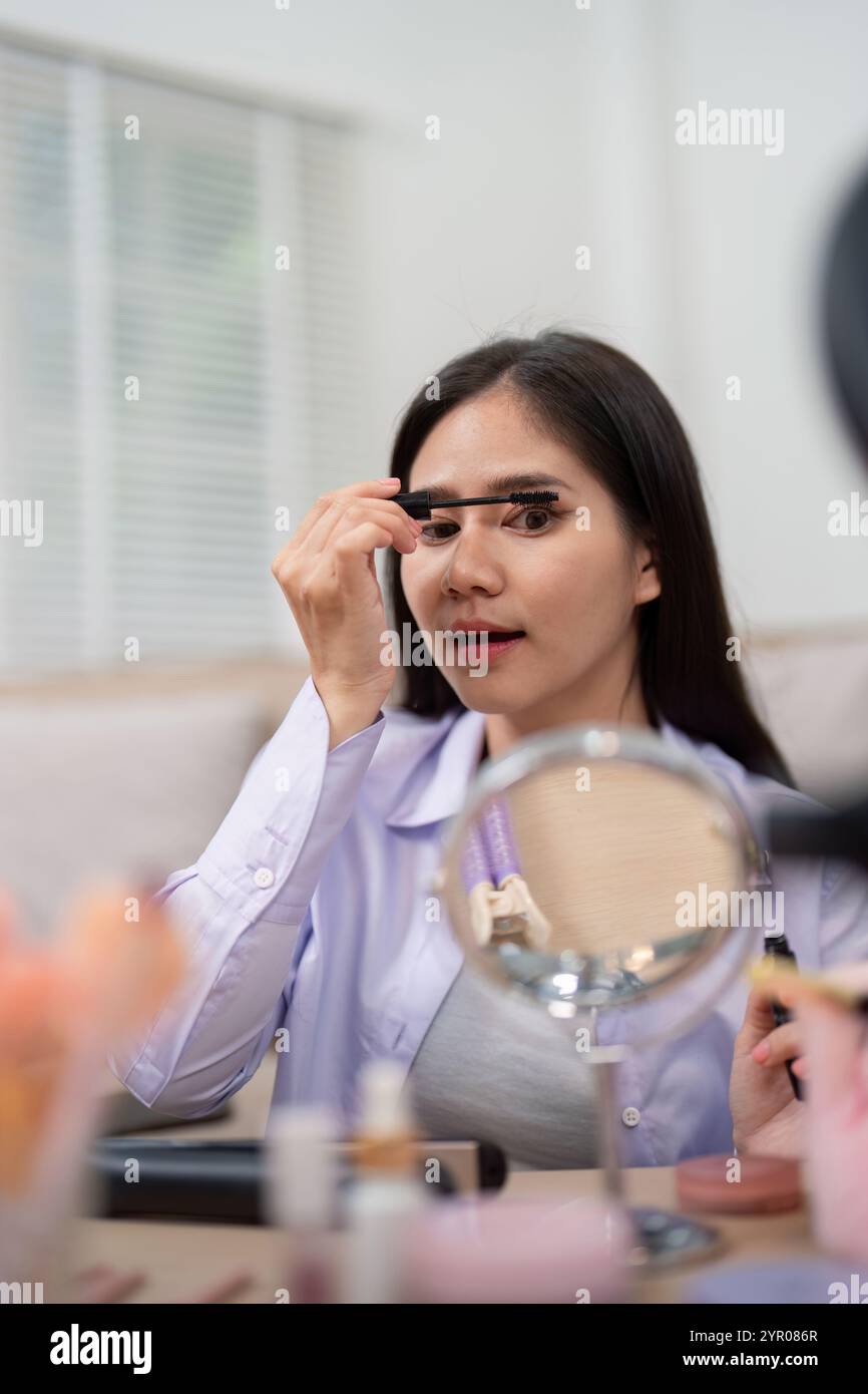 Focused young woman applying hi-res stock photography and images - Alamy
