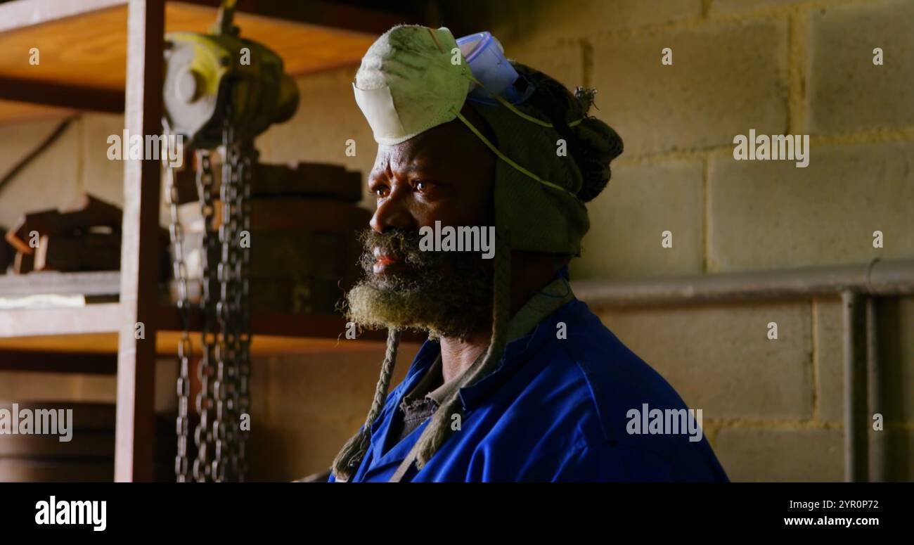 Thoughtful worker standing in foundry workshop Stock Photo