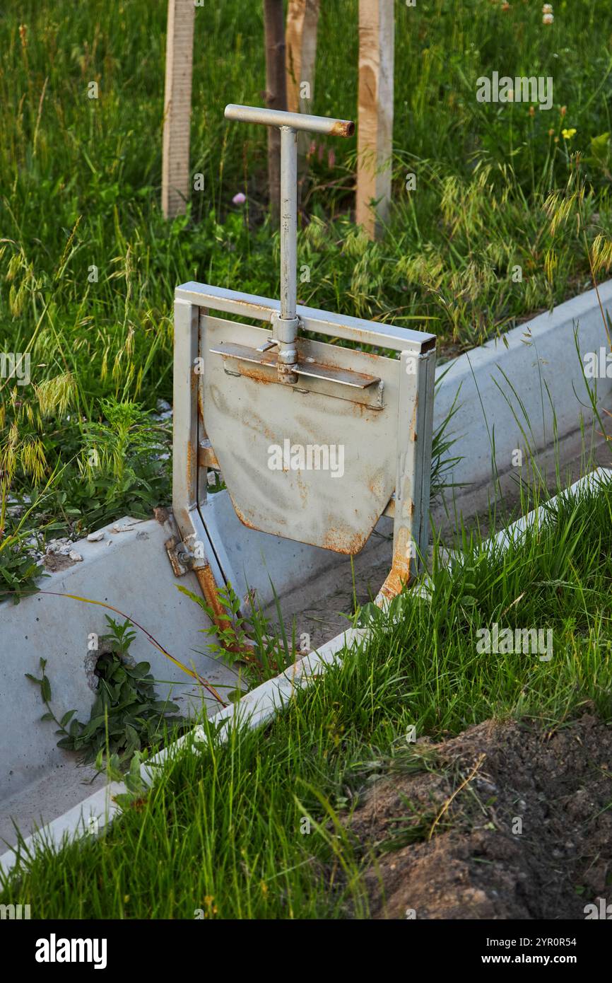 Irrigation ditch, drained aryk in city park, a hydraulic structure in form of small concrete irrigation canal for urban vegetation in Bishkek, Kyrgyzs Stock Photo