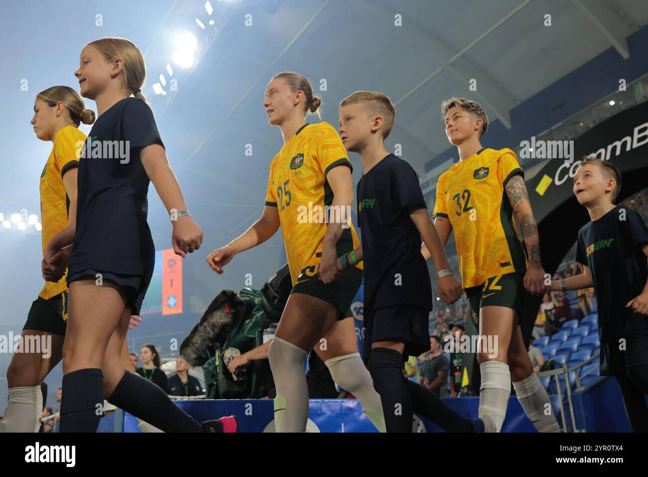 Gold Coast, Australia. 01st Dec, 2024. Robina, Australia, December 1st 2024: Kyra Cooney-Cross (23), Clare Hunt (25) and Michelle Heyman (32 Matildas) walk out with mascots before the friendly international match between Australias CommBank Matildas and Brazil Women at the Cbus Super Stadium, Robina, Australia Matthew Starling (Promediapix/SPP) Credit: SPP Sport Press Photo. /Alamy Live News Stock Photo