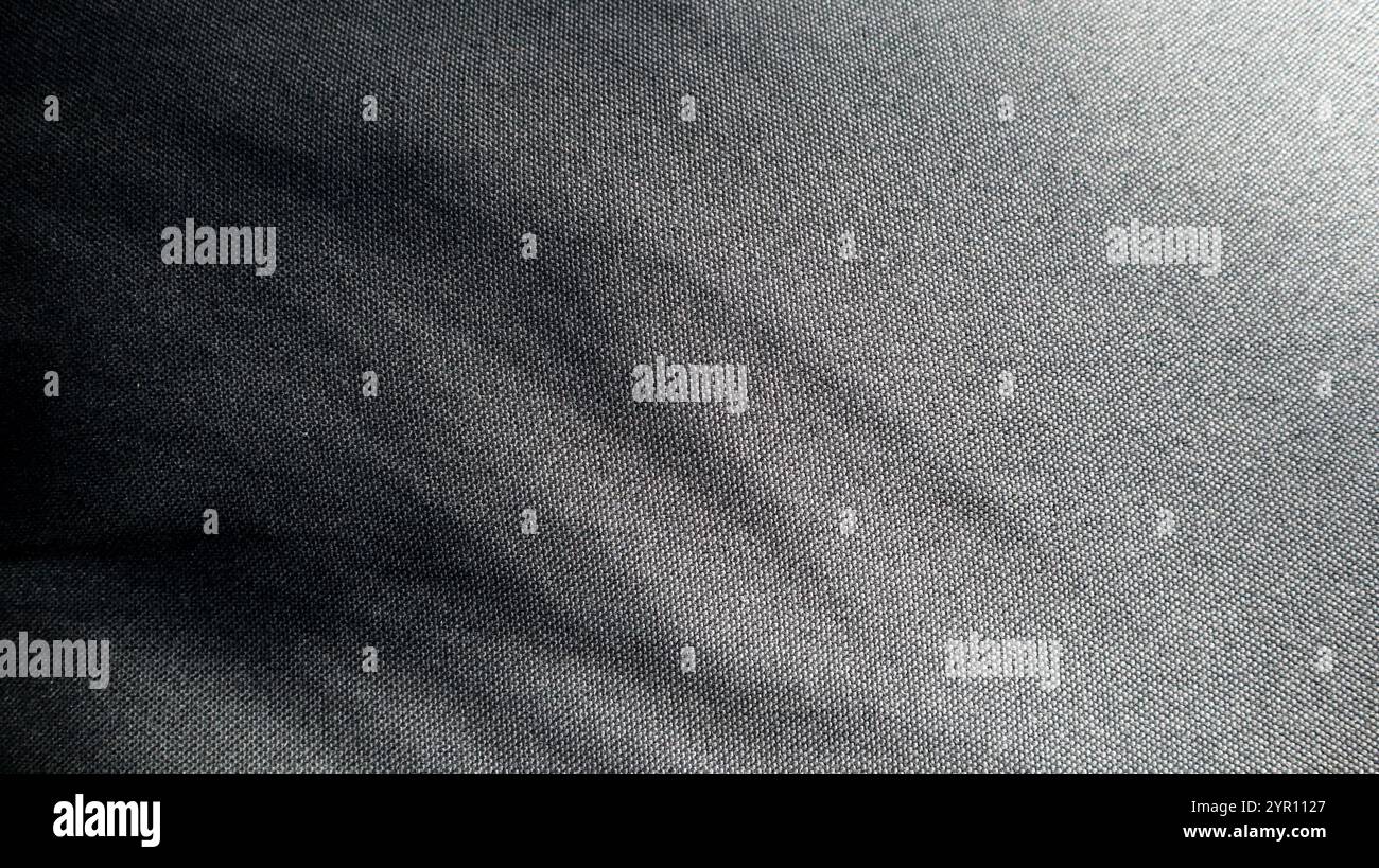 Photo of textured fabric of black color. From the upper left corner ...