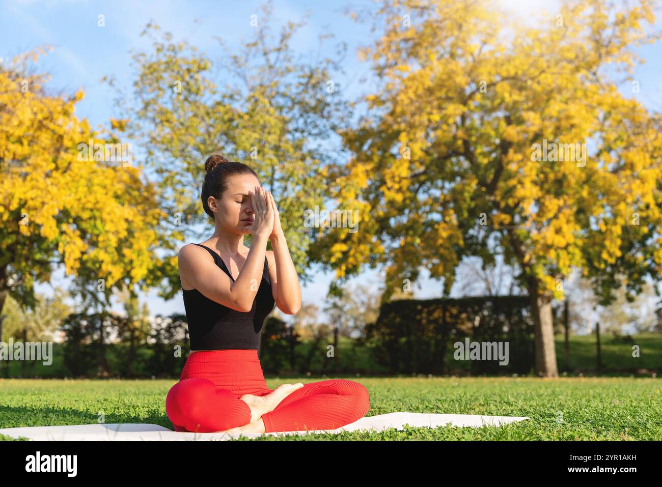 Woman in a park meditating hi-res stock photography and images - Alamy