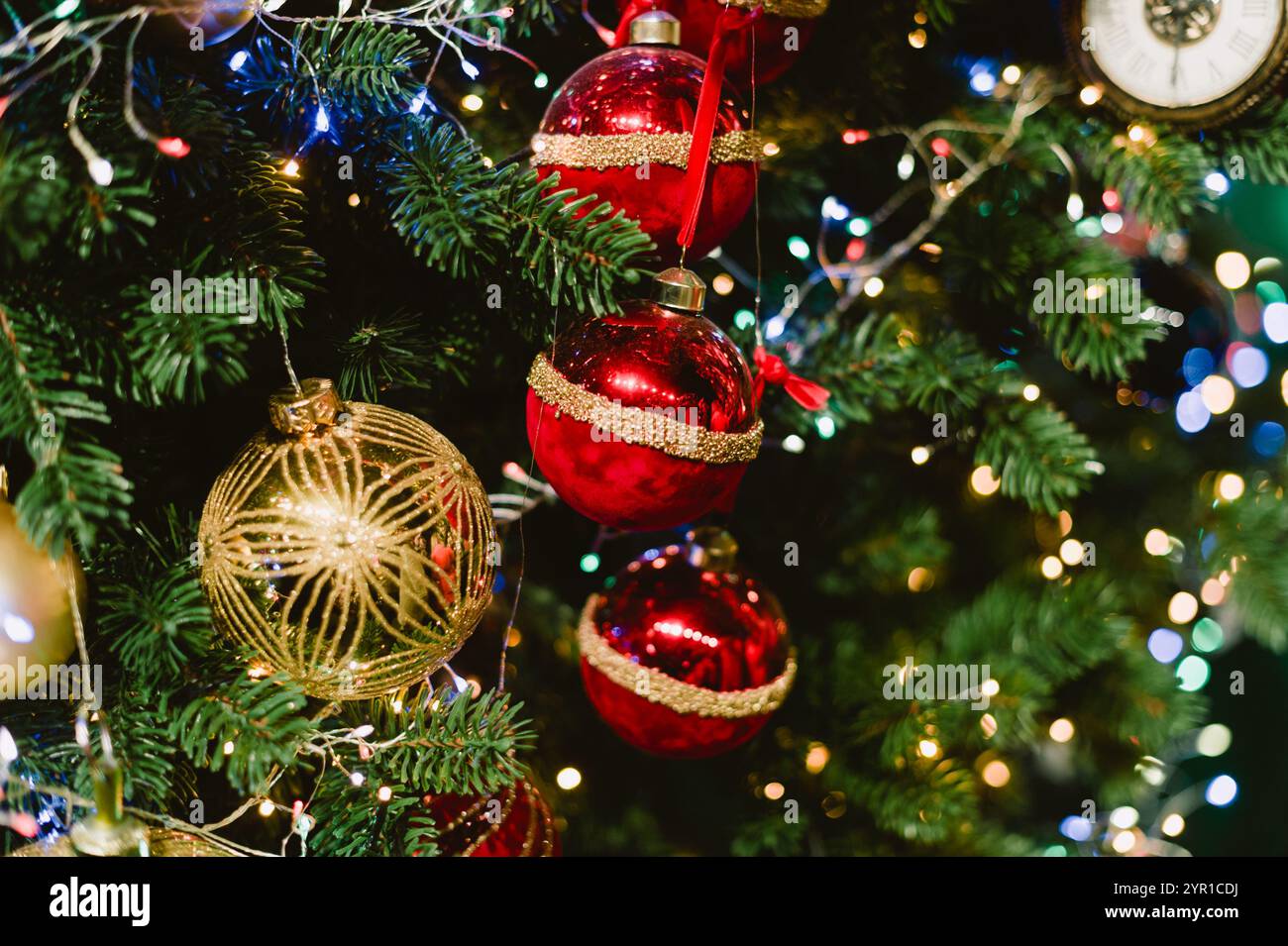 A Christmas tree with red and gold ornaments. The tree is lit up with ...