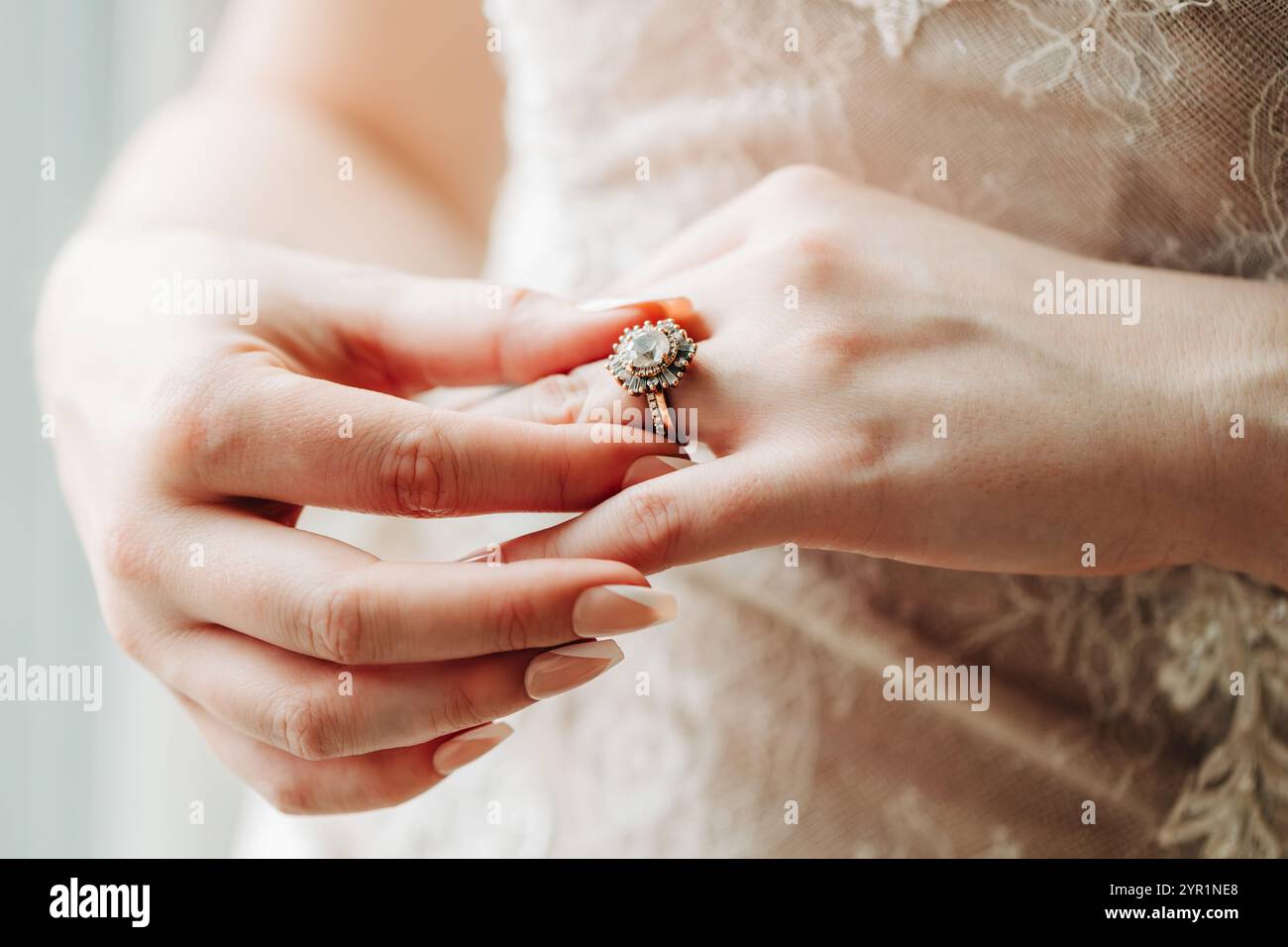 Macro photo of bride's hands and art deco wedding ring Stock Photo