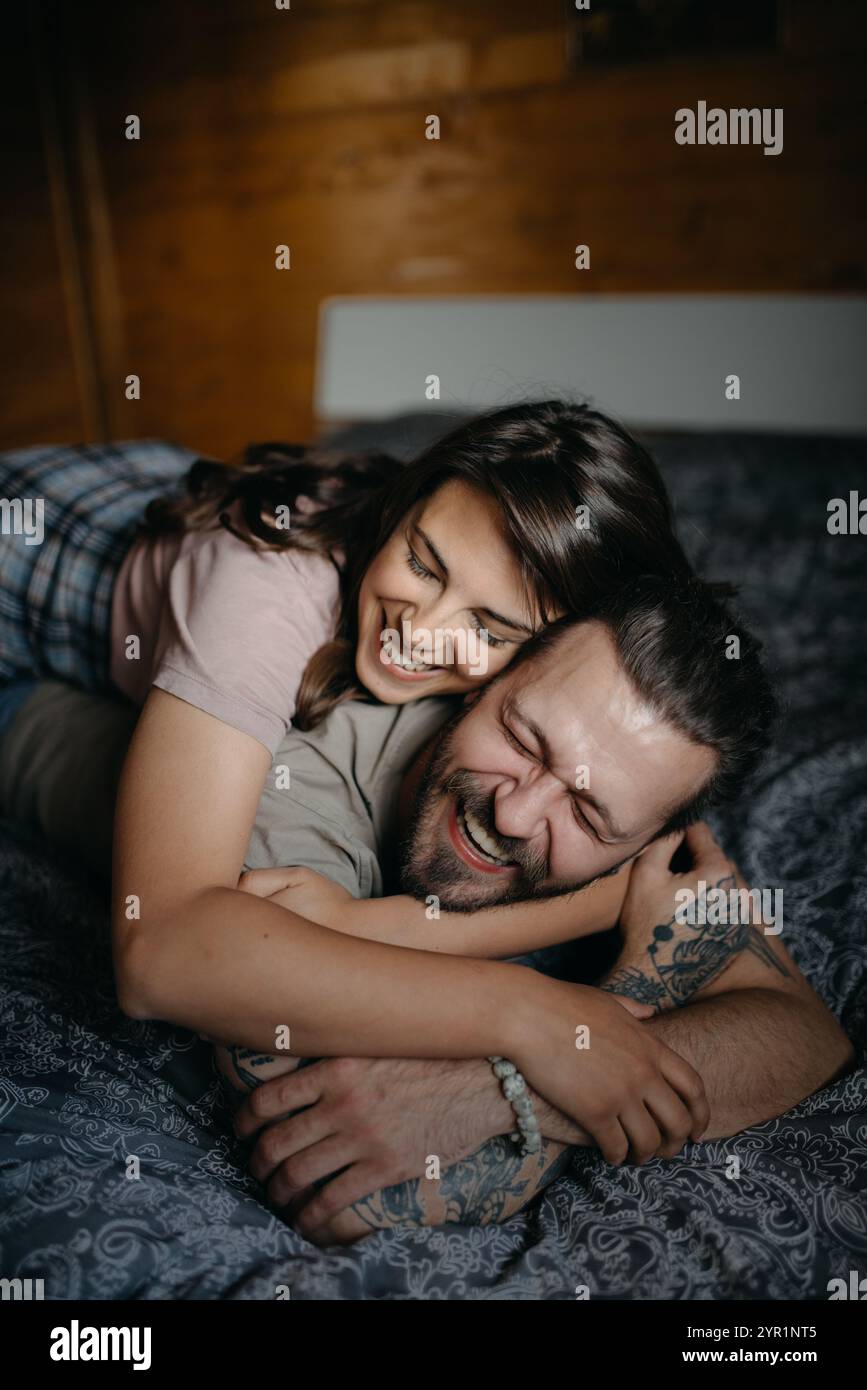 Embracing young couple on the bed closeup. Stock Photo
