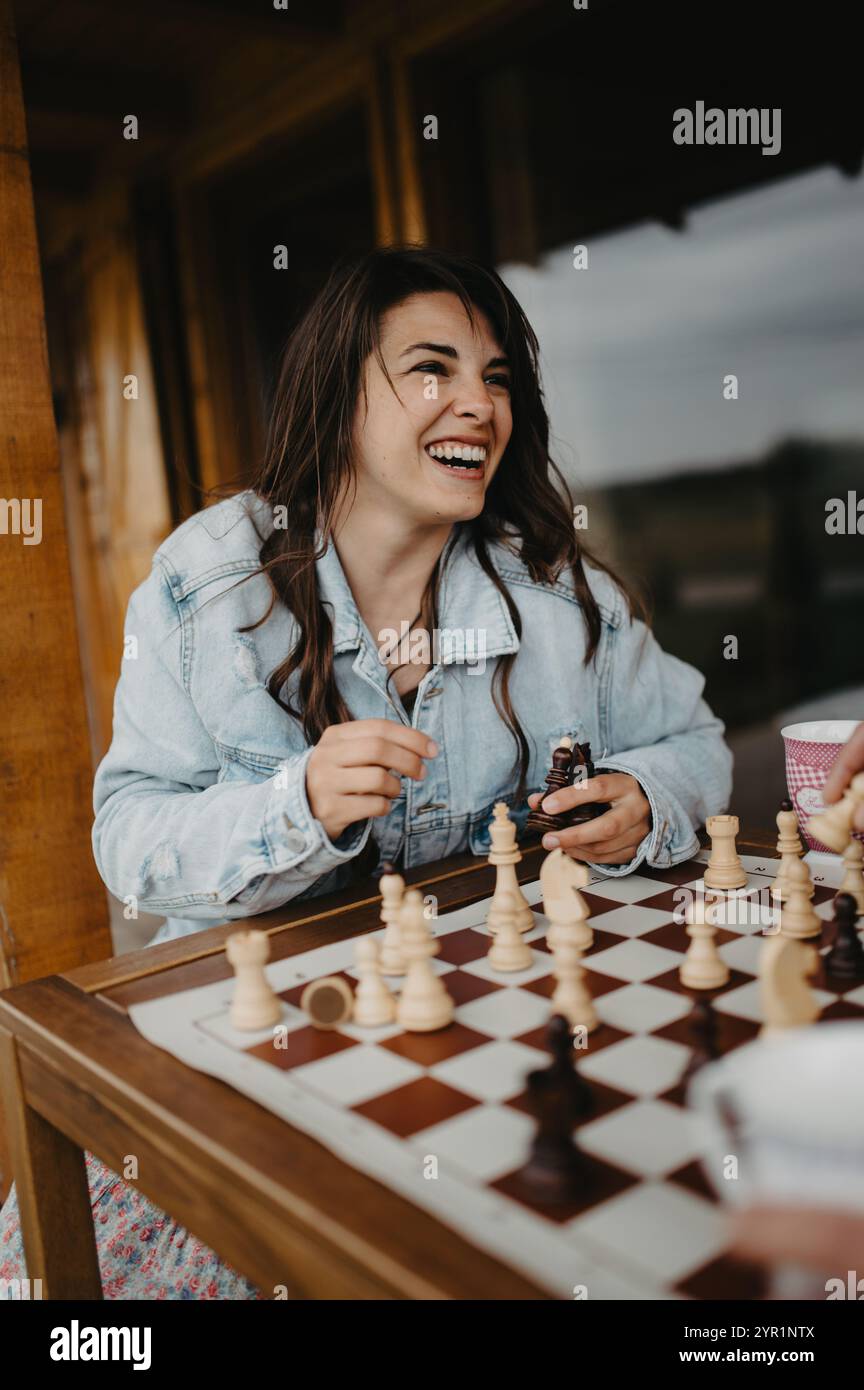 Happy smiling girll holding chess pieces. Stock Photo