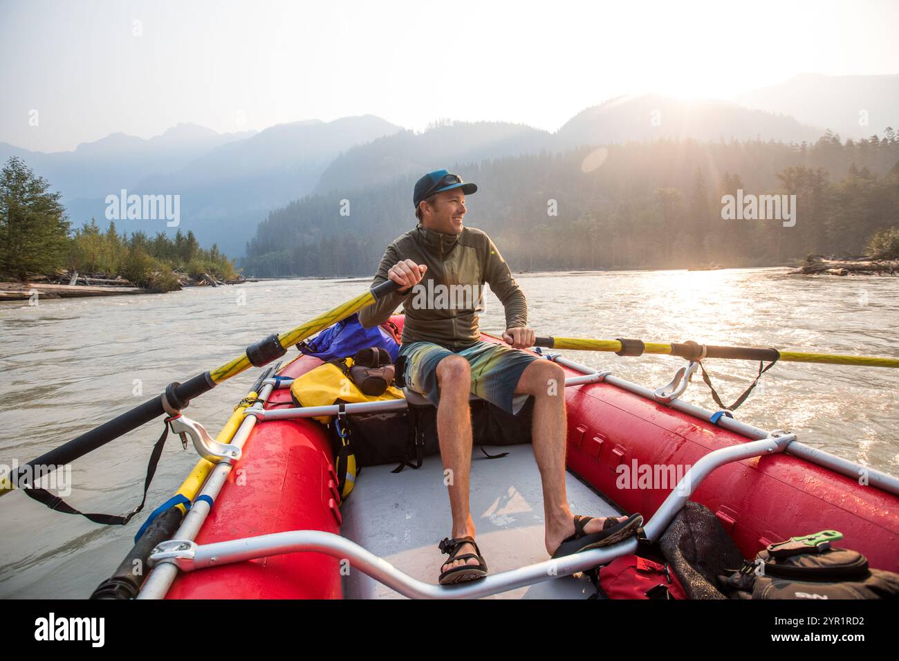 Person Rowing A Raft Guide rowing red raft on river at sunrise Stock Photo - Alamy