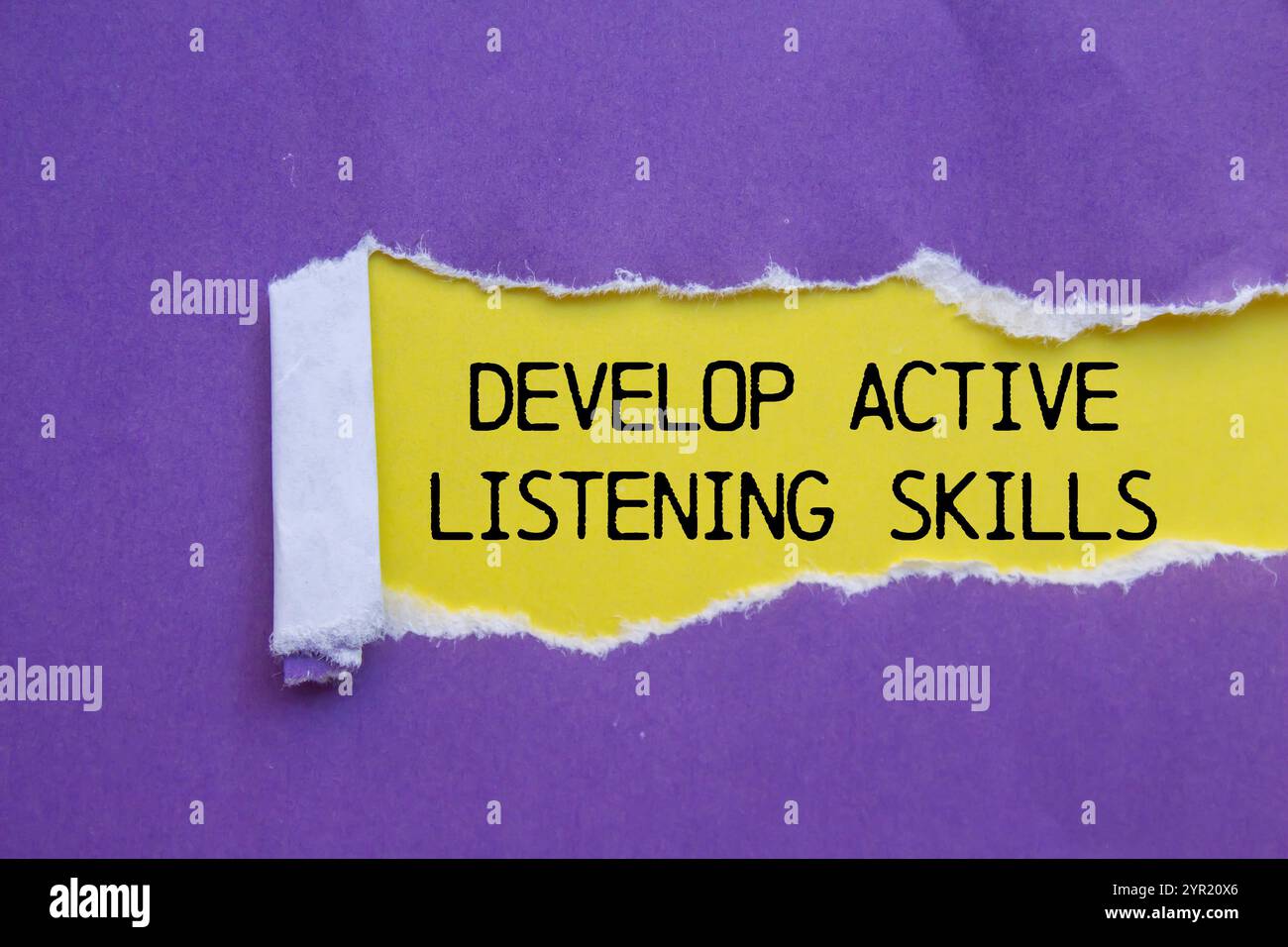 Develop active listening skills message written on ripped torn purple ...