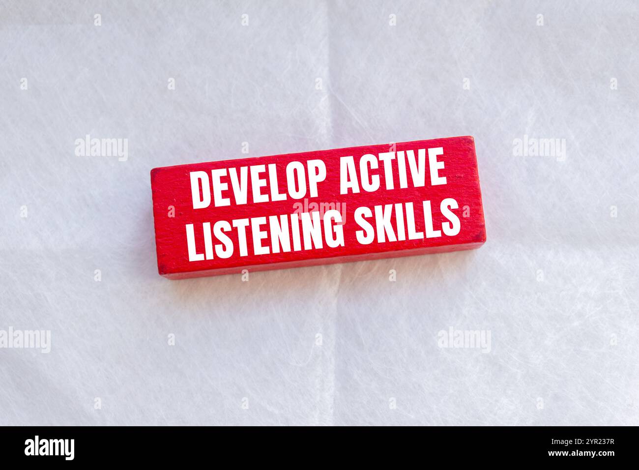 Develop active listening skills message written on wooden red block ...