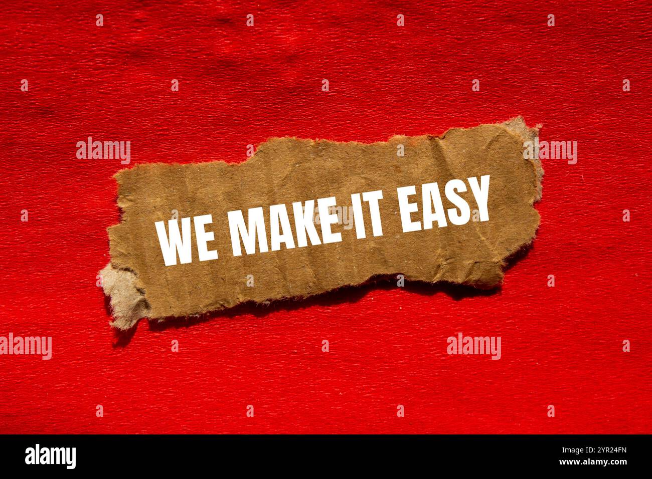 We make it easy message written on ripped torn cardbaord paper piece ...