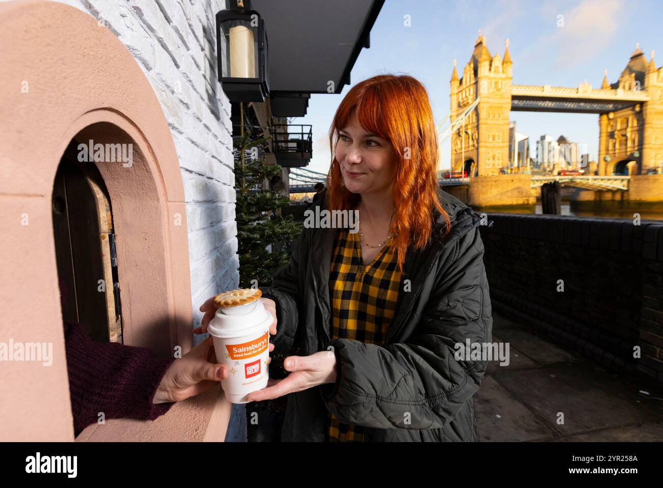 EDITORIAL USE ONLY A 'Magical mince pie window' in London, created by Sainsbury's in partnership with Comic Relief, is unveiled as part of a nationwide initiative, including openings in Manchester, Birmingham, and Newcastle, to give away mince pies and warm spiced tea for free. Picture Date: Monday December 2, 2024. Stock Photo