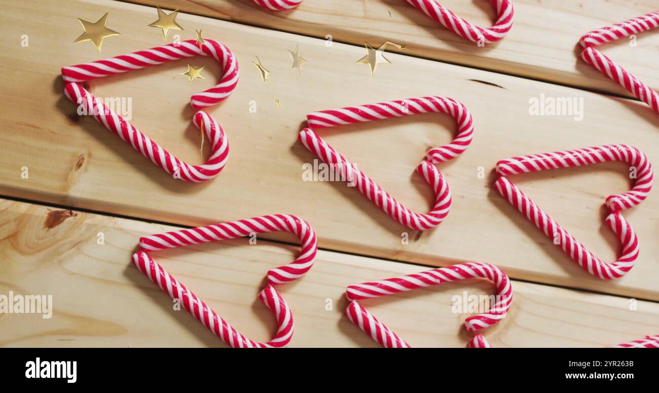 Candy cane hearts and stars image over wooden background Stock Photo