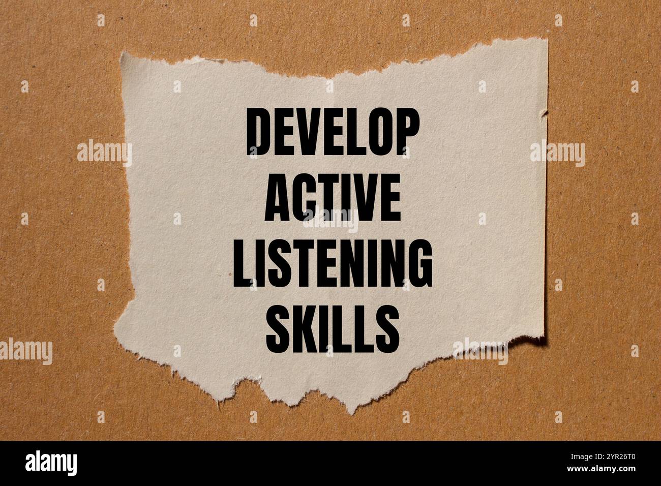 Develop active listening skills message written on ripped torn paper ...