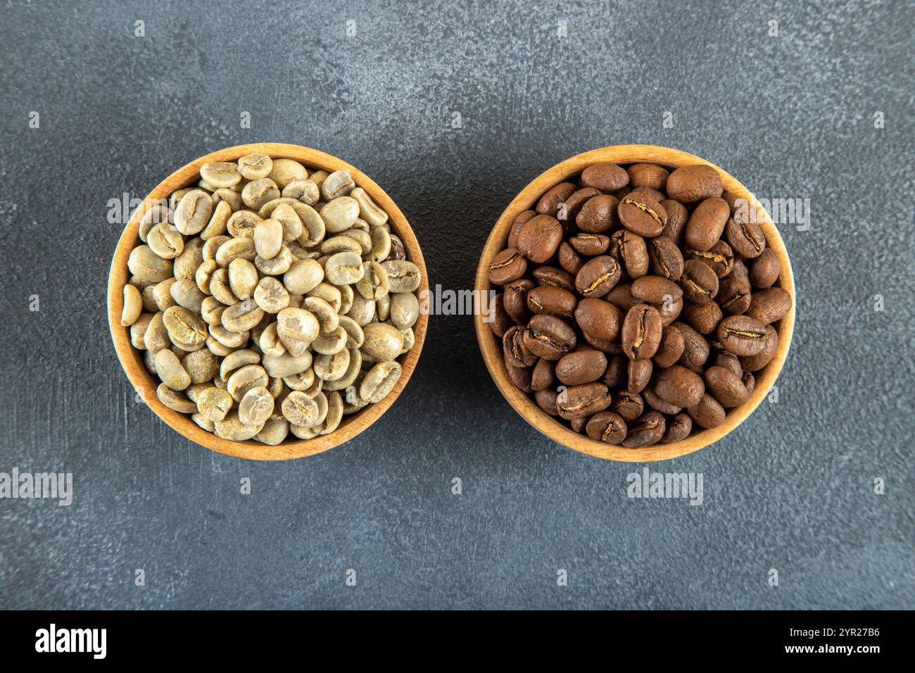 Green coffee with roasted coffee beans on gray background Stock Photo