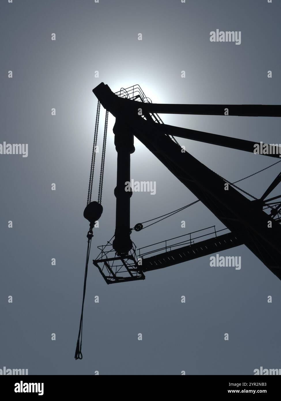 Silhouette of an industrial crane against a clear blue sky at the Giardini in Venice - Smartphone Captured Stock Image