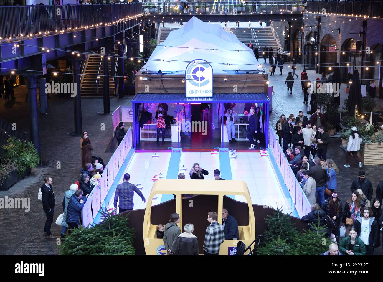 Kings Cross Club Curling, fun winter activity in Coal Drops Yard, north London, UK Stock Photo