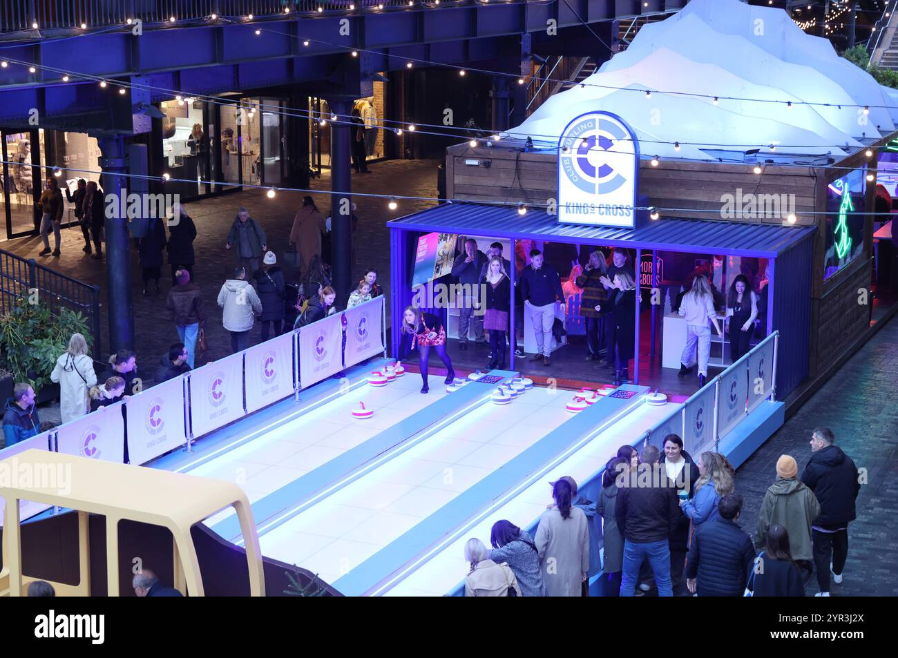 Kings Cross Club Curling, fun winter activity in Coal Drops Yard, north London, UK Stock Photo