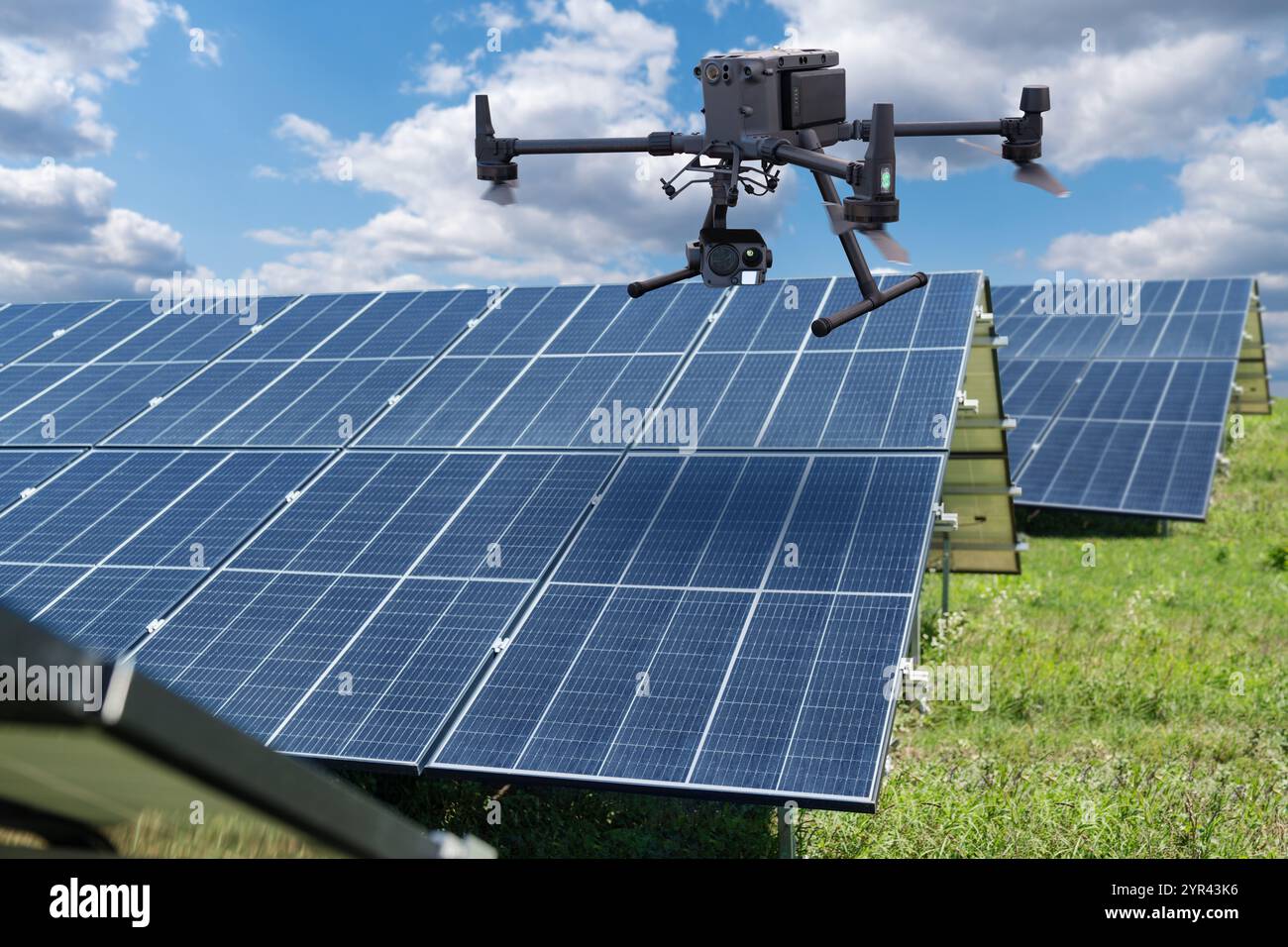 Industrial drone inspects solar panels. Stock Photo