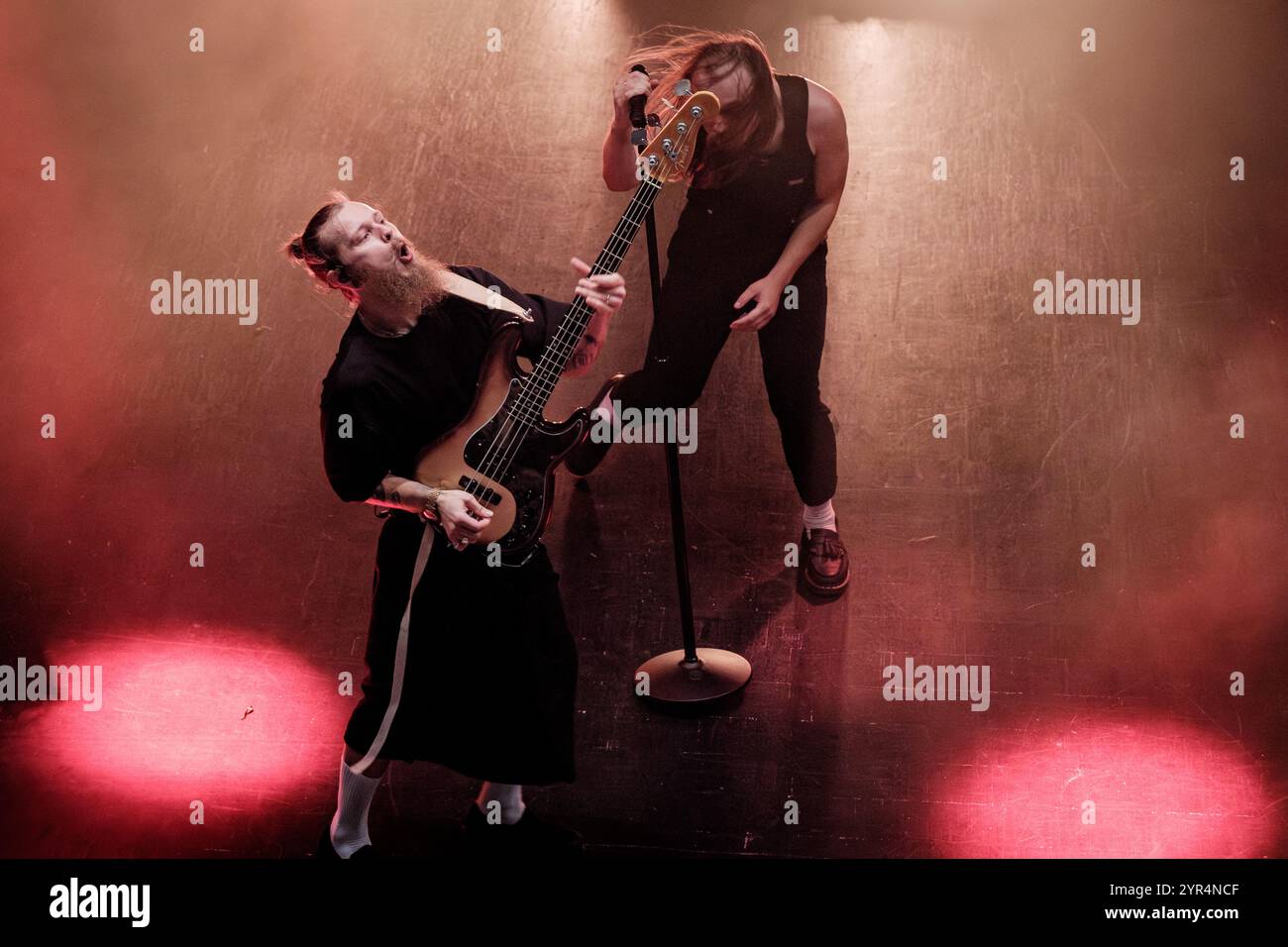 Pavel Kozlov (bass) running around Egor Shkutko (vocals) while on stage with Molchat Doma, live on stage on 9th November 2024 at Fållan for the Stockholm, Sweden date of their Belaya Polosa tour. Stock Photo