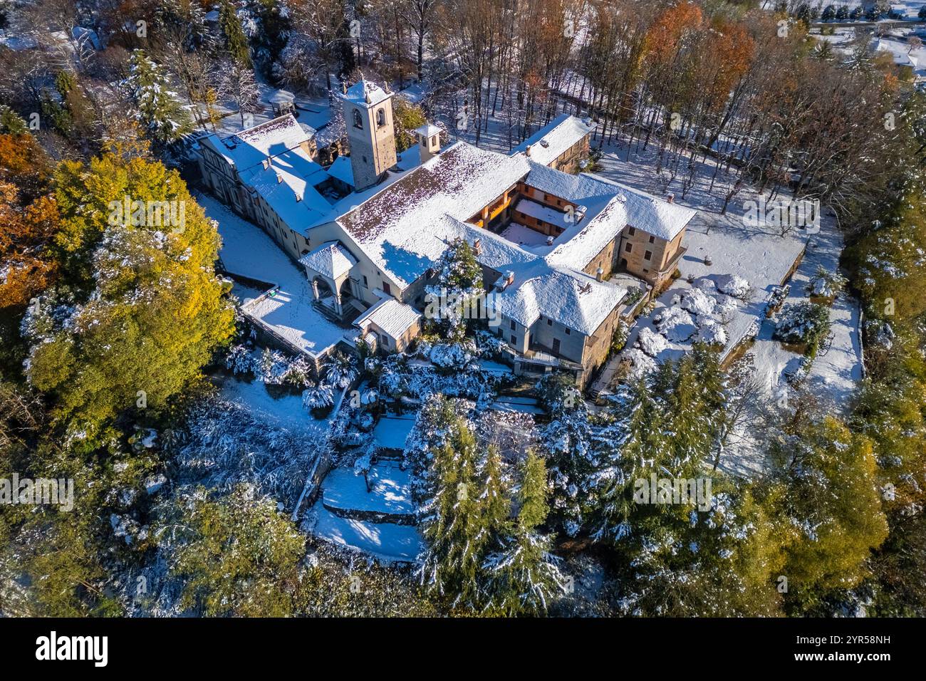 Aerial view of the Sacro Monte of Orta and San Giulio island on Lake Orta in winter after a snowfall. Orta Lake, Province of Novara, Piedmont, Italy. Stock Photo