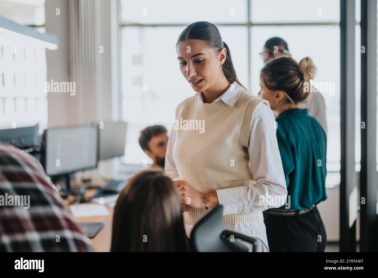 Business professionals collaborating in a modern office setting meeting Stock Photo