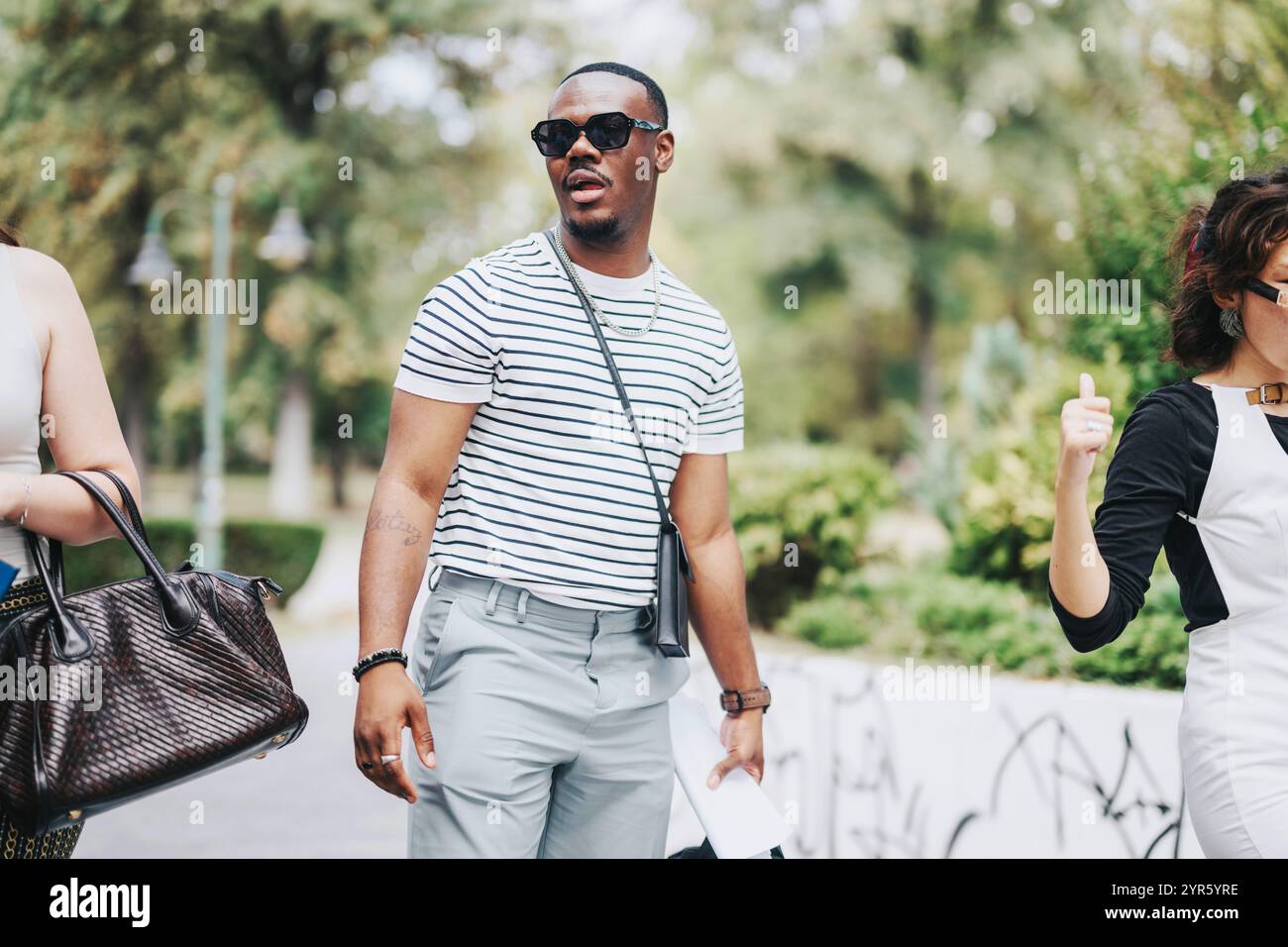Business people walking through a serene park setting Stock Photo - Alamy