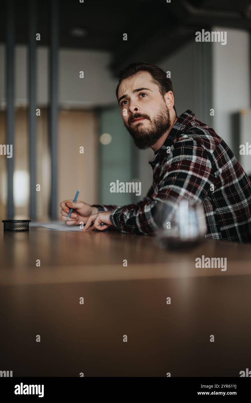 Focused man attentively listening during a business meeting discussion Stock Photo