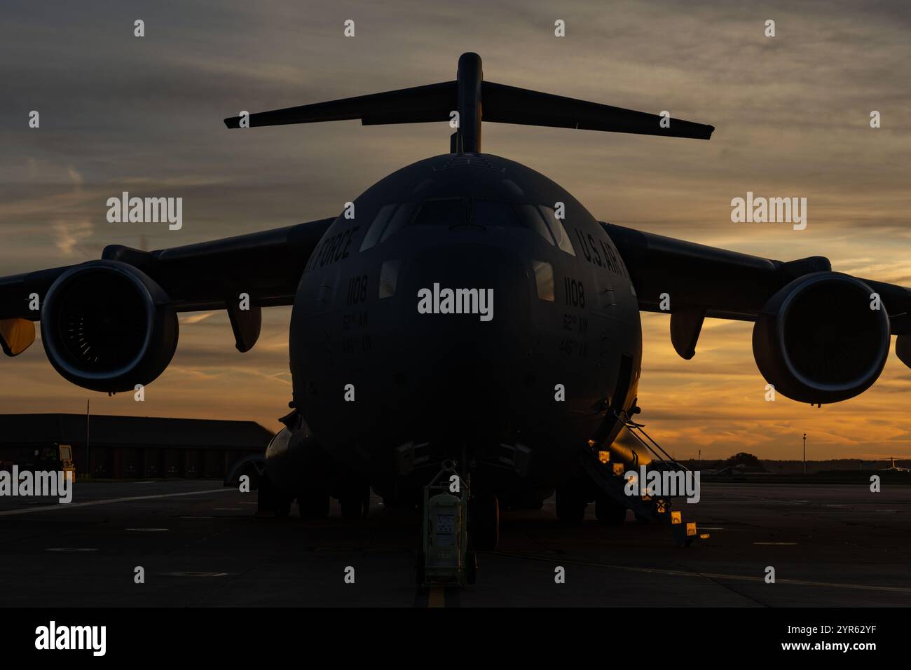 A U.S. Air Force C-17 Globemaster III from the 67th Airlift Wing, Joint Base Lewis-McChord, Washington, sits on a taxiway at Royal Air Force Mildenhall, England, Nov. 29, 2024. The 727th Air Mobility Squadron, in coordination with RAF Lakenheath, supported the President of the United States by loading two R-11 Refueler trucks onto a C-17. The deployment of fuel trucks, along with other ground support equipment like power carts, is planned to meet the demanding operational needs of presidential missions. (U.S. Air Force photo by Staff Sgt. Jesenia Landaverde) Stock Photo