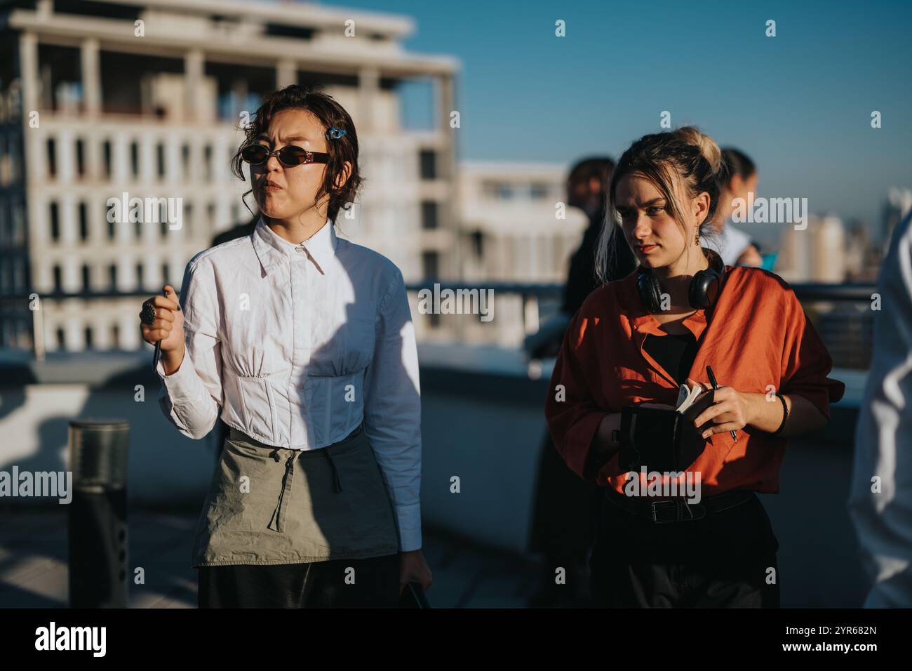 Multicultural business workers discussing a project on rooftop Stock Photo