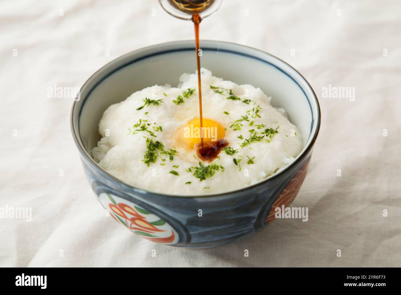 Tororo Rice Tororo rice topped with quail's egg and soy sauce Stock Photo - Alamy