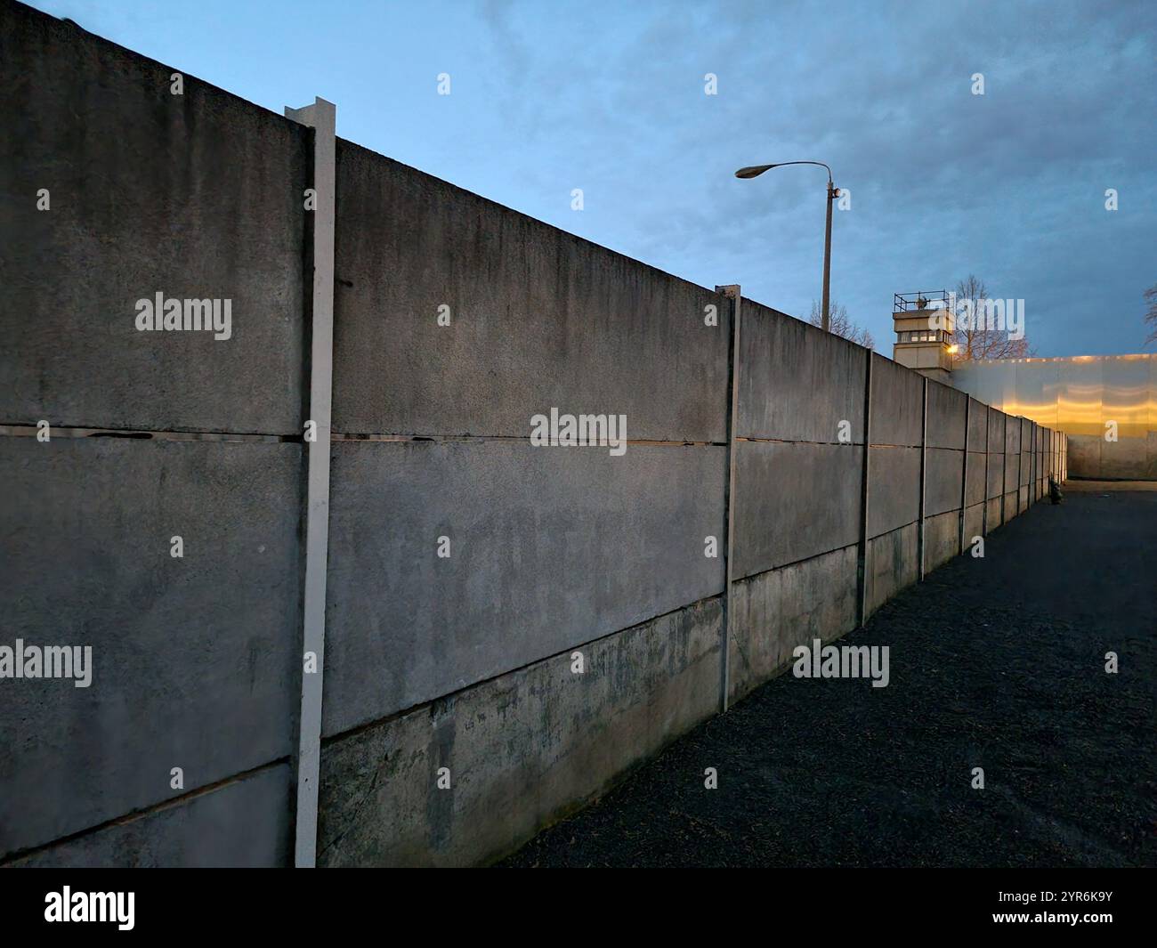 Berlin Wall with border strip and watchtower in the Berlin Wall Memorial on Bernauerstrasse, Berlin, Germany; locked up concept - Smartphone Captured Stock Image