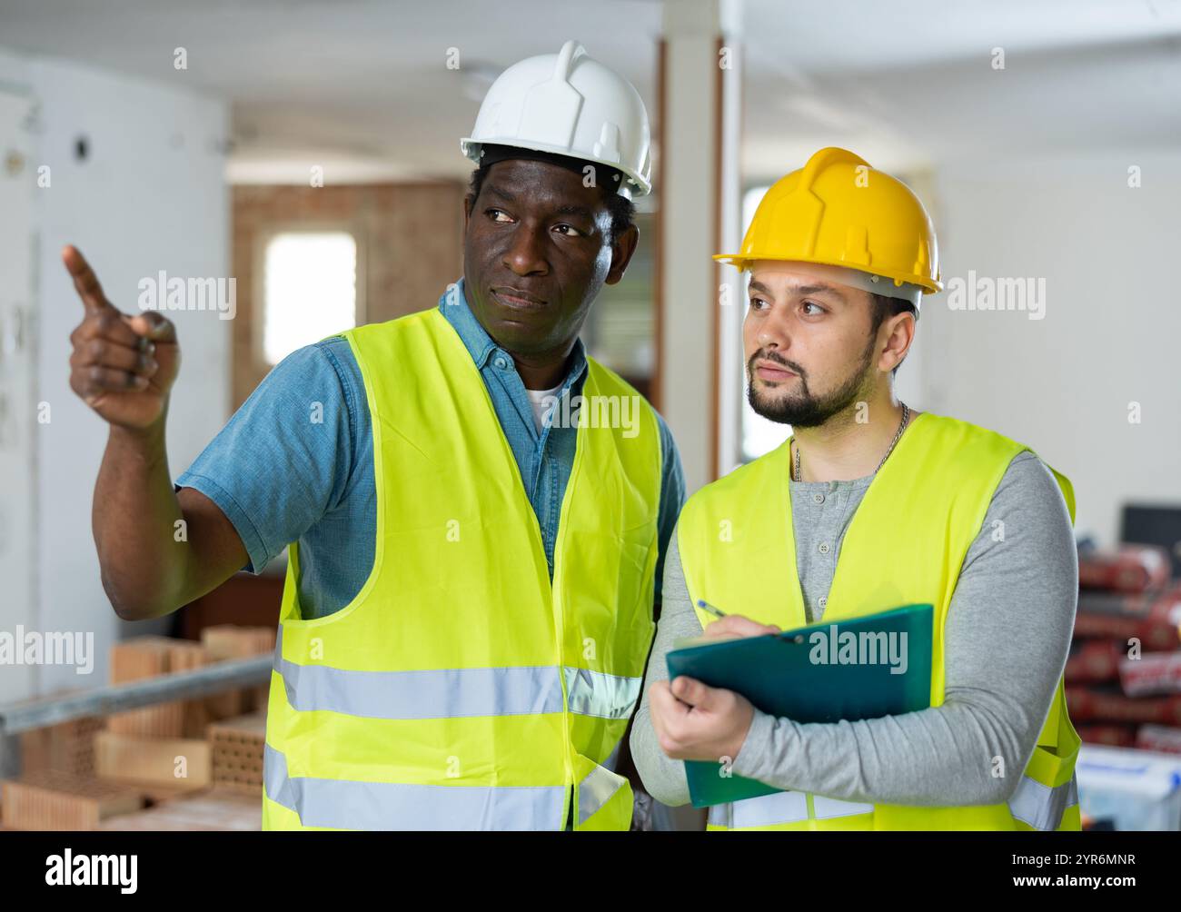 Two engineers discussing work in apartment Stock Photo