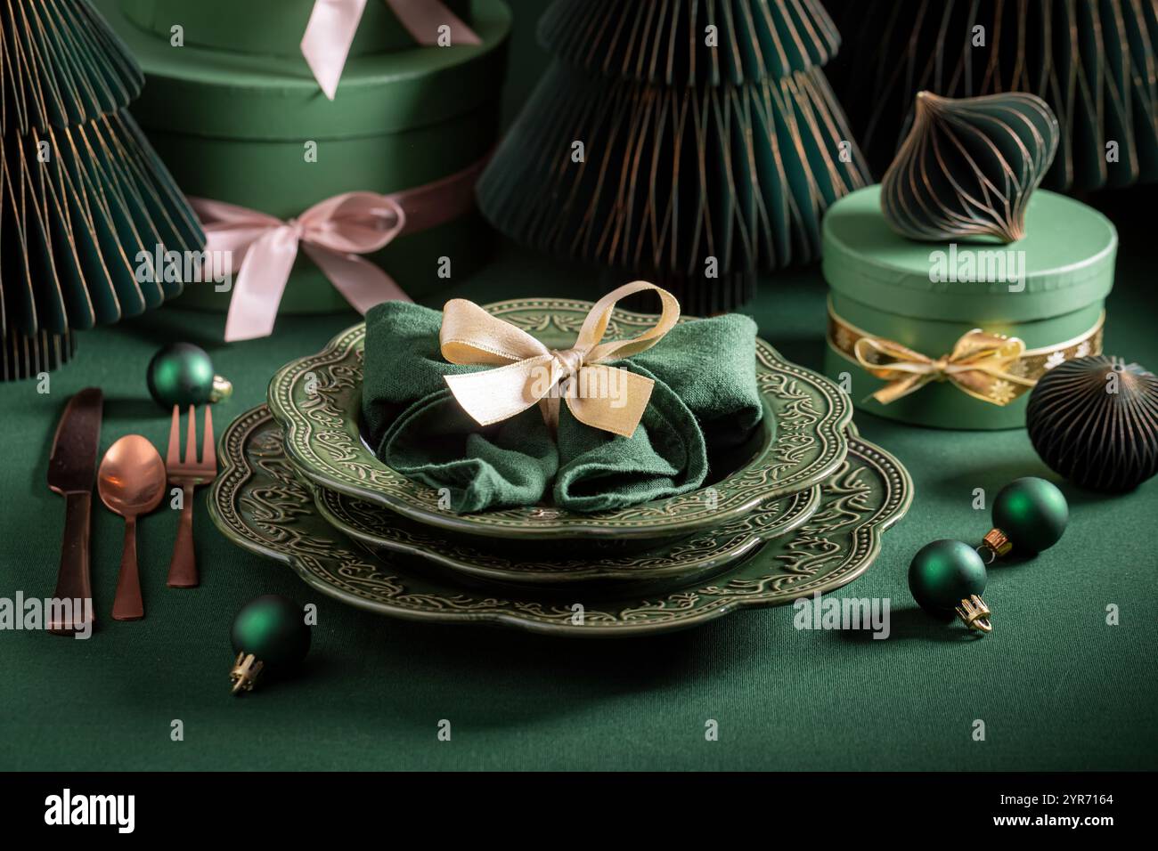 Modern dark green table set for Christmas with Christmas decorations ...