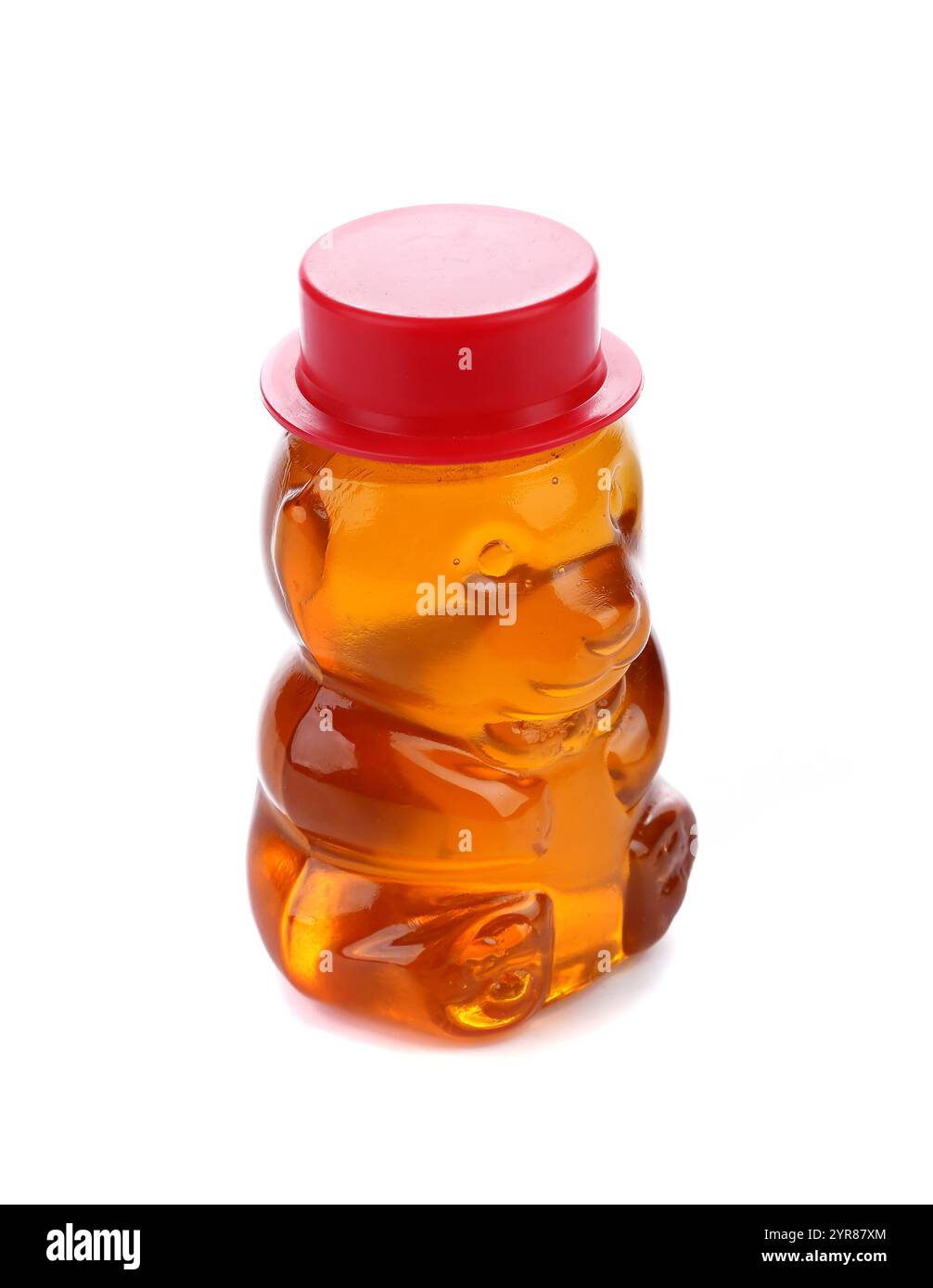 Bottle shaped like a bear and filled with honey. White bckground. Stock Photo