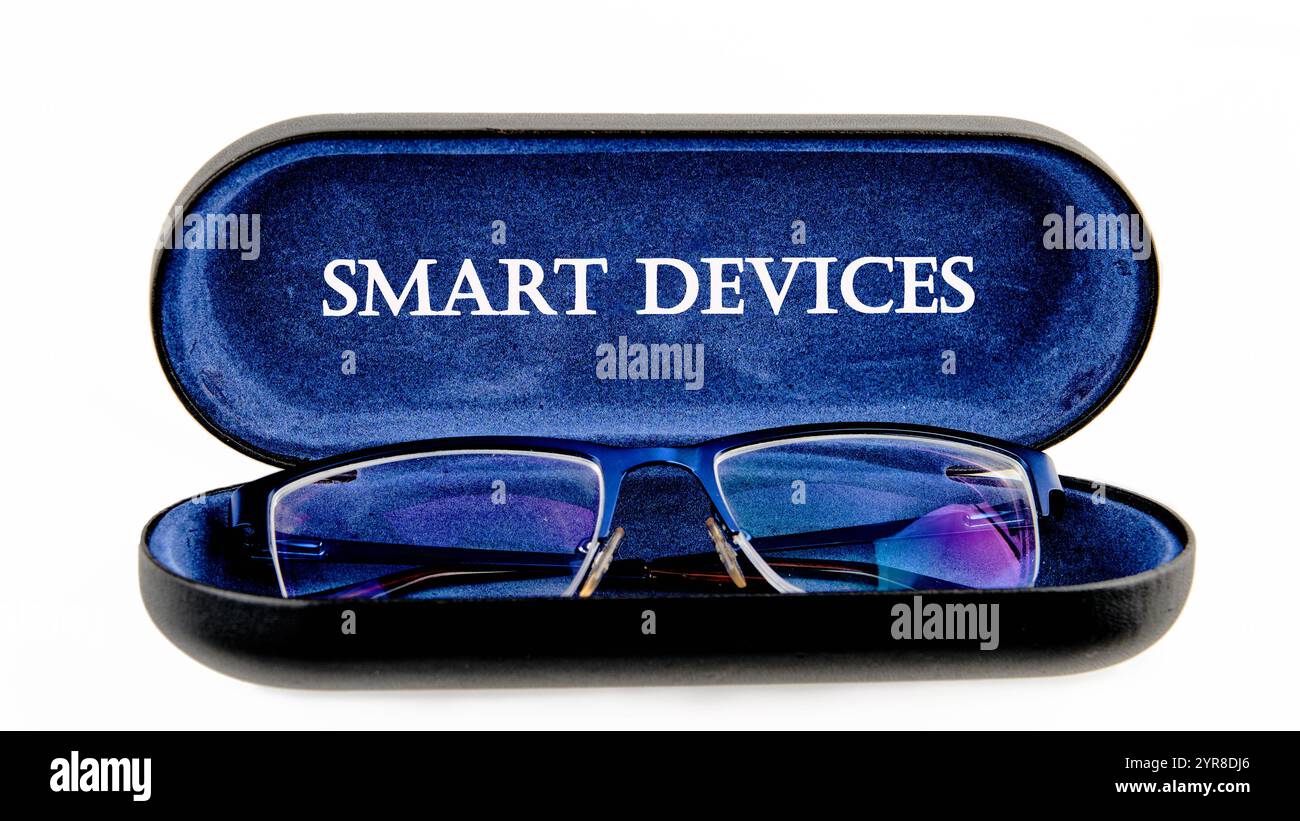 The concept of technology and development. Phrase, words, text SMART DEVICES written on the open case of the glasses case. Stock Photo
