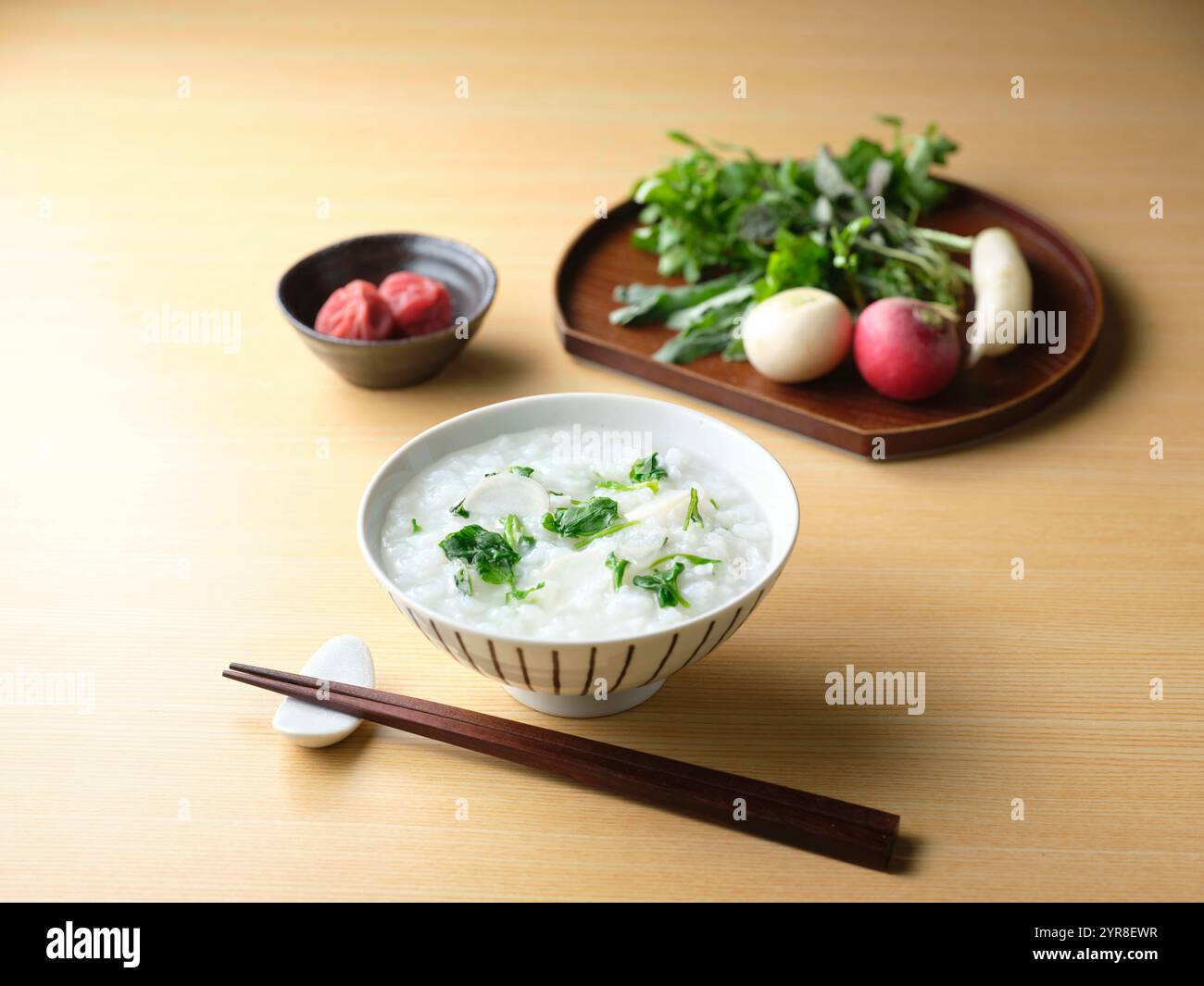 Rice gruel with seven herbs and pickled plums Stock Photo