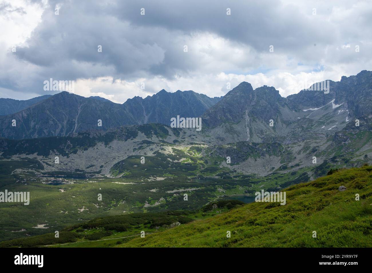 Dramatic Mountain Range under Cloudy Sky Stock Photo
