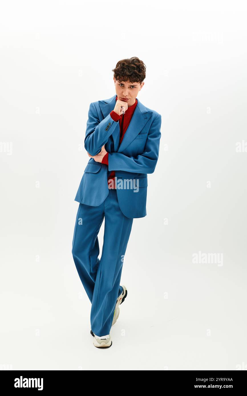A handsome man in a blue suit displays confidence and style, capturing ...