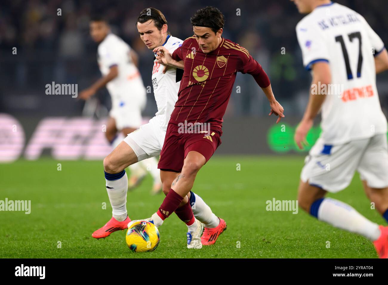 Marten de Roon of Atalanta BC and Paulo Dybala of AS Roma compete for ...